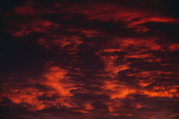 istock Fiery red blood vampire dawn. Amazing warm dramatic fire cloudy sky. Vivid orange sunlight. Atmospheric background of sunrise in overcast weather. Hard cloudiness. Storm clouds warning. Copy space. 1135219128
