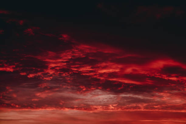 istock Fiery red blood vampire dawn. Amazing warm dramatic fire cloudy sky. Vivid orange sunlight. Atmospheric background of sunrise in overcast weather. Hard cloudiness. Storm clouds warning. Copy space. 1135219133