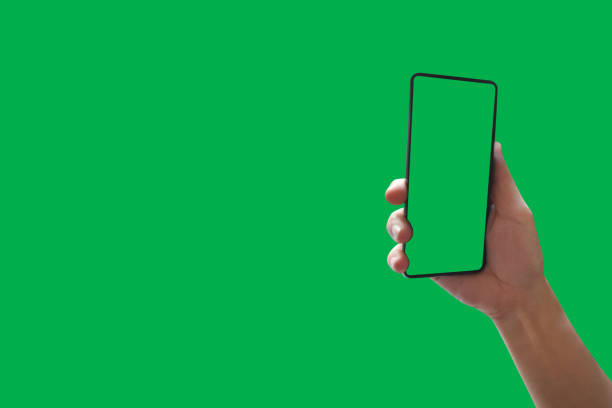 istock Top view holding hand smartphone with green screen Isolated on background with clipping path. 1135224606