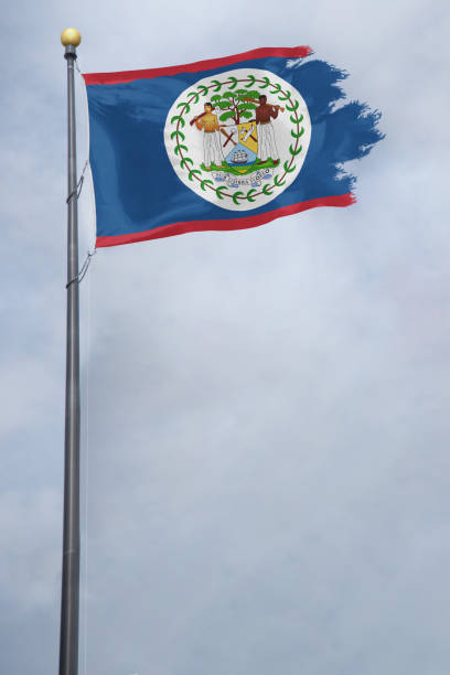 istock Belize Flag with a torn edge, blowing in a storm 1135225679