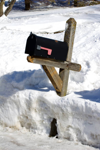 istock Old rural mailbox and post in a deep snow bank 1135230220