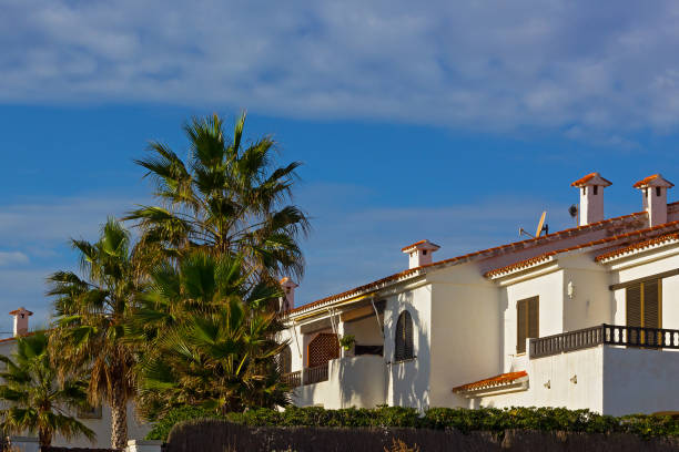 istock A row of Mediterranean beach summer cottages under blue sky. 1135235663