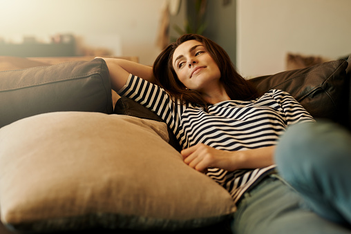 Shot of a beautiful young woman relaxing at home