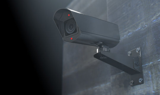 A wireless surveillance camera with illuminated lights mounted on a wall in the night-time with copy space - 3D render
