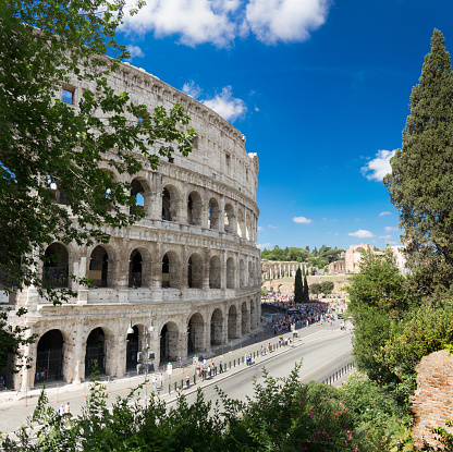 Luxurious colosseum among trees. Rome, Italy