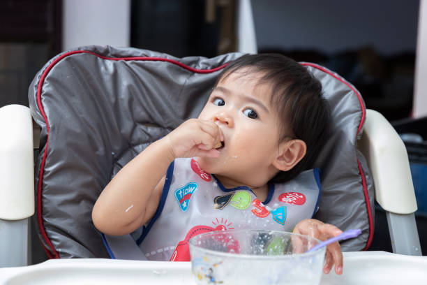 istock Close up baby eating meal. 1135249959