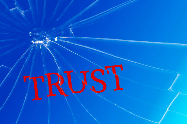The text Trust on the broken glass. Deceived trust. Lie concept. Background