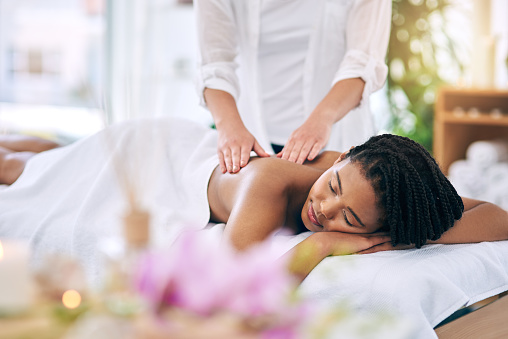 Shot of an attractive young woman getting a massage at a spa