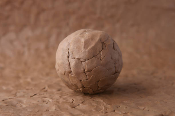 Clay ball on modeling natural clay surface. Wet clay material for craft. clay stock pictures, royalty-free photos & images