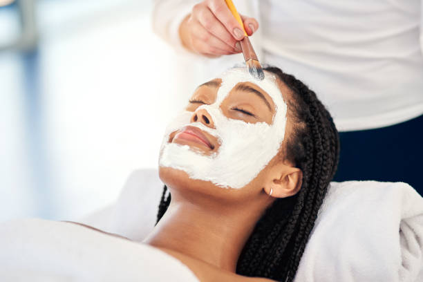 Do it for your glow Shot of an attractive young woman getting a facial at a beauty spa facial chemical peel stock pictures, royalty-free photos & images