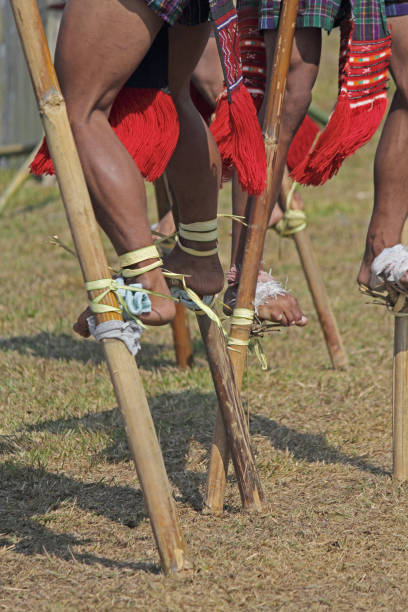 istock Nocte warrior tribes, playing bamboo stilts game 1135253881