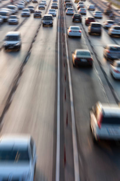 istock Blurry image of rush hour traffic on busy highway at sunset 1135254739