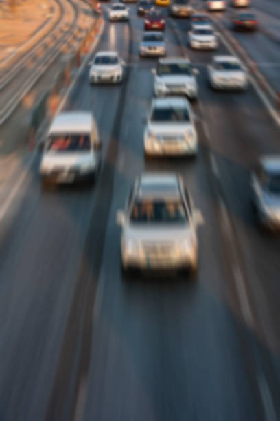istock Blurry image of rush hour traffic on busy highway at sunset 1135254758