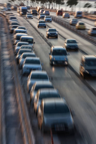 istock Blurry image of rush hour traffic on busy highway at sunset 1135254826