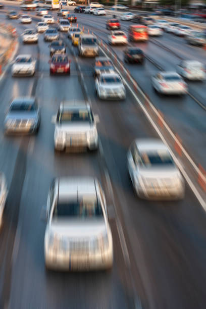 istock Blurry image of rush hour traffic on busy highway at sunset 1135254935