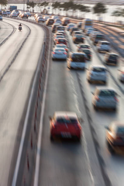 istock Blurry image of rush hour traffic on busy highway at sunset 1135256102