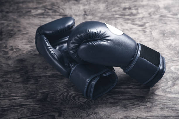 istock Boxing gloves on old wooden table. 1135257046