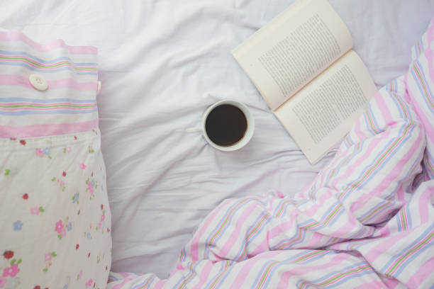 istock Coffee and book on the bed 1135258137