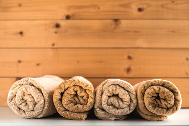 istock Rolled up bath towels on wooden background. 1135258602