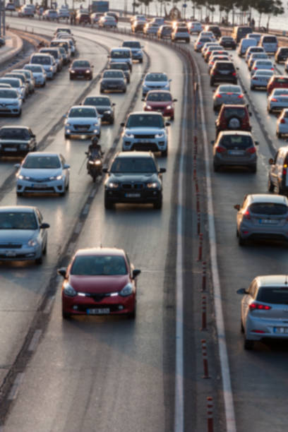 istock Blurry image of rush hour traffic on busy highway at sunset 1135258624