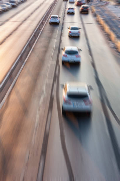 istock Blurry image of rush hour traffic on busy highway at sunset 1135258757