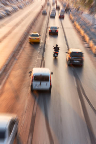 Blurry image of rush hour traffic on busy highway at sunset