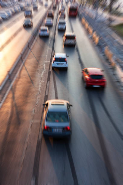 istock Blurry image of rush hour traffic on busy highway at sunset 1135259396