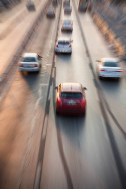 istock Blurry image of rush hour traffic on busy highway at sunset 1135259577