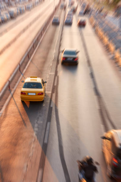 istock Blurry image of rush hour traffic on busy highway at sunset 1135259851