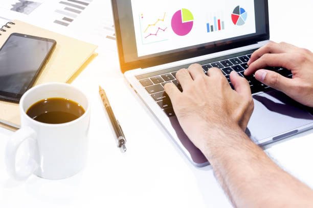 istock Businessman workspace laptop with coffee cup ,computer screen graphics and charts 1135263554