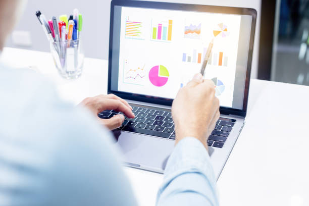 istock Businessman workspace laptop with coffee cup ,computer screen graphics and charts 1135264612