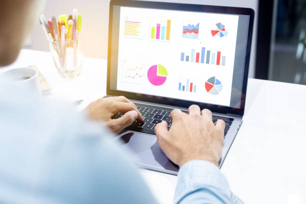 istock Businessman workspace laptop with coffee cup ,computer screen graphics and charts 1135264616
