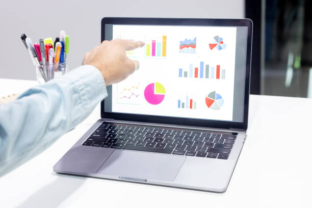istock Businessman workspace laptop with coffee cup ,computer screen graphics and charts 1135265903