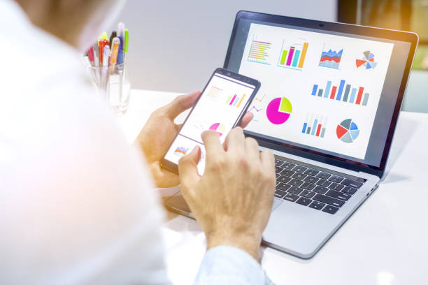 istock Businessman workspace laptop with coffee cup ,computer screen graphics and charts 1135265904