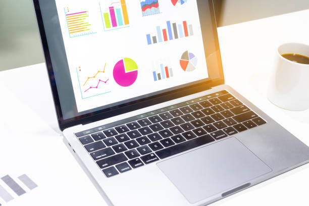 istock Businessman workspace laptop with coffee cup ,computer screen graphics and charts 1135265905