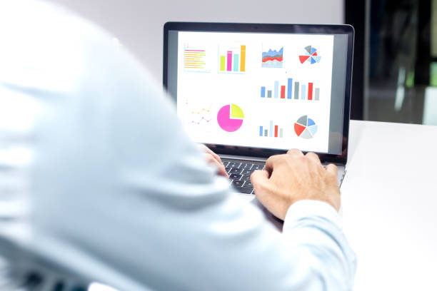 istock Businessman workspace laptop with coffee cup ,computer screen graphics and charts 1135265907
