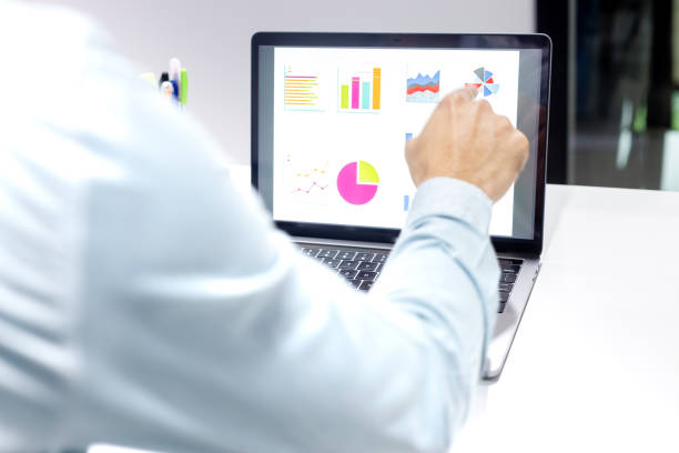 istock Businessman workspace laptop with coffee cup ,computer screen graphics and charts 1135266166