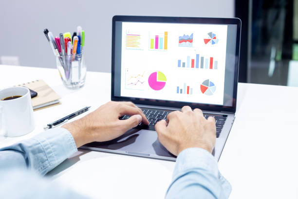 istock Businessman workspace laptop with coffee cup ,computer screen graphics and charts 1135266232