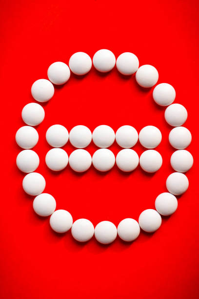 White pills arrange in Stop sign. Film coated tablets of Minerals, anti stress formula on red background