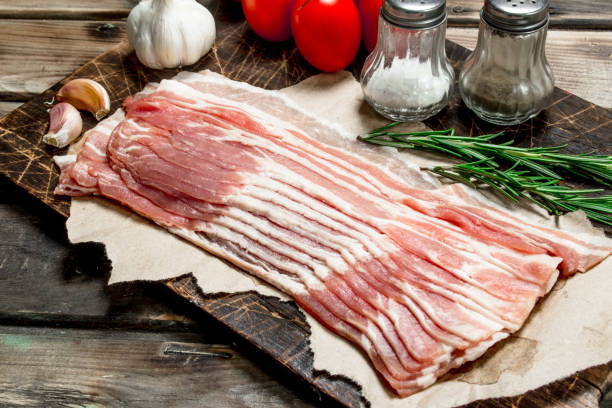 istock Raw bacon with vegetables, herbs and spices. 1135270052