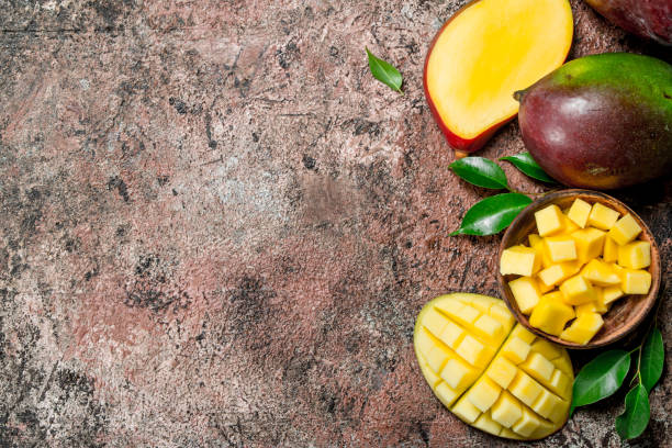 istock Mango pieces in a bowl with foliage. 1135270179