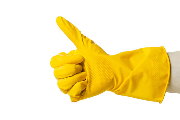 istock Hand in a rubber glove shows gestures. Symbolism. On white background. 1135271906