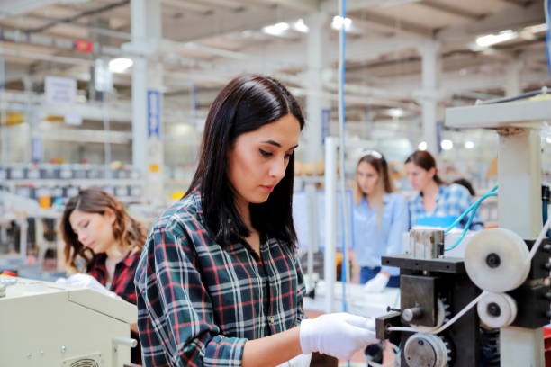 gruppe von arbeitern, die an der produktionslinie in der fabrik arbeiten - arbeitsintensive produktion stock-fotos und bilder