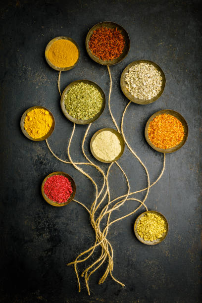 Various bowls of spices over dark background