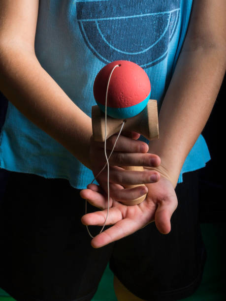 istock Classic Japanese game kendama, boy hands playing kendama 1135273380