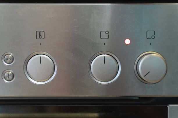Close-up Circular button to control the temperature in the microwave oven. Button to warm food on gray background