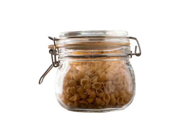 istock raw pasta jar in a glass vintage style jar isolated white 1135274844