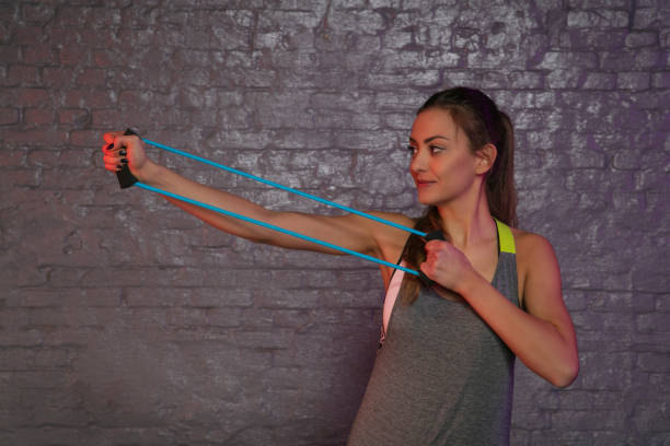 istock young beautiful girl practicing at the gym with rubbers 1135275500