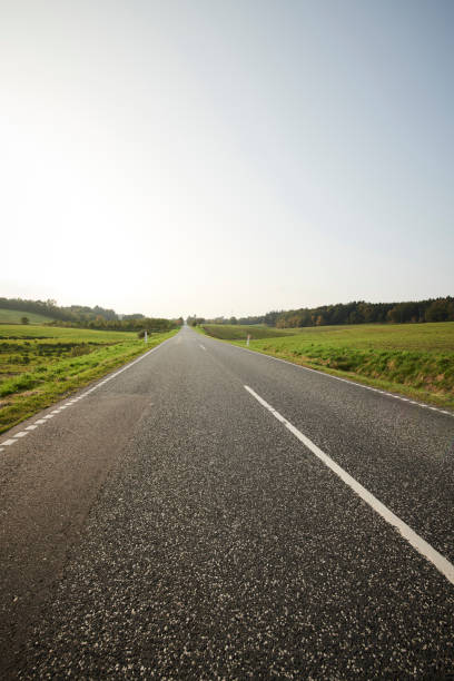 istock Landscape with green fields and a long road 1135275980