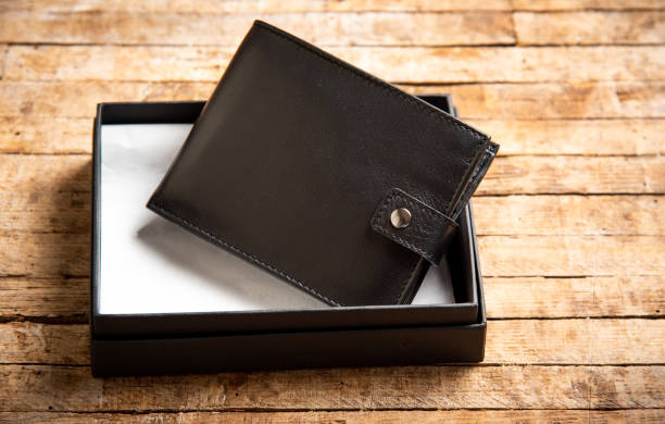 istock Black leather wallet on a wooden table 1135276828